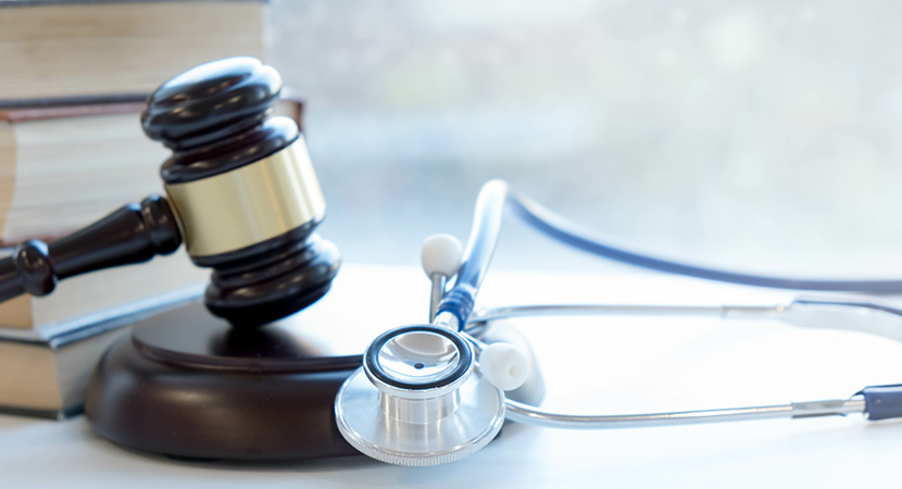 A gavel and stethoscope representing the relationship between CMS and the pharmaceutical industry and ongoing IRA updates and negotiations between the two.