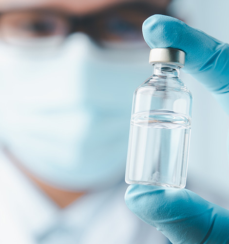Specialty pharma manufacturer worker holding up medication